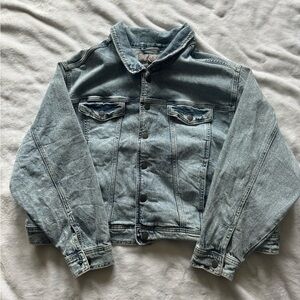 Button up jean jacket. Denim color, buttons down the middle and on wrist cuffs.